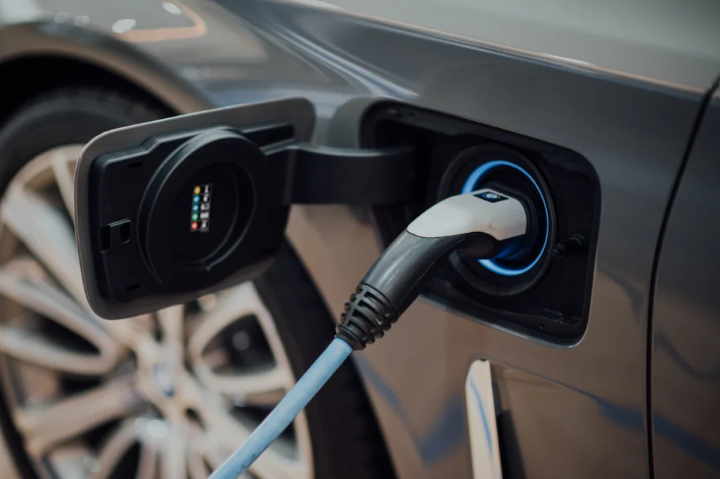 Electric vehicle charging cable connected to a car's charging port.